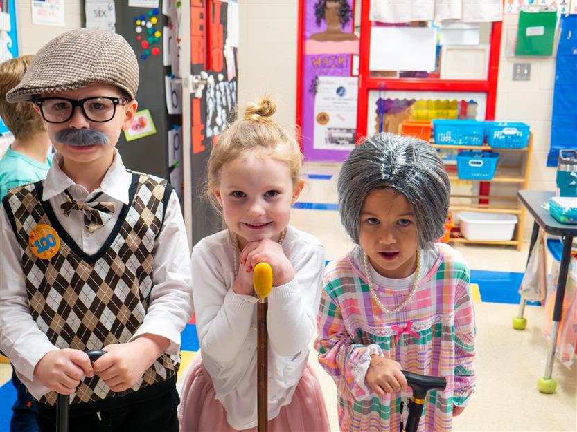 three students dressed as 100 year olds